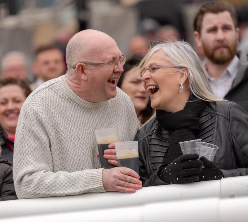 A couple having a good laugh at the track side.