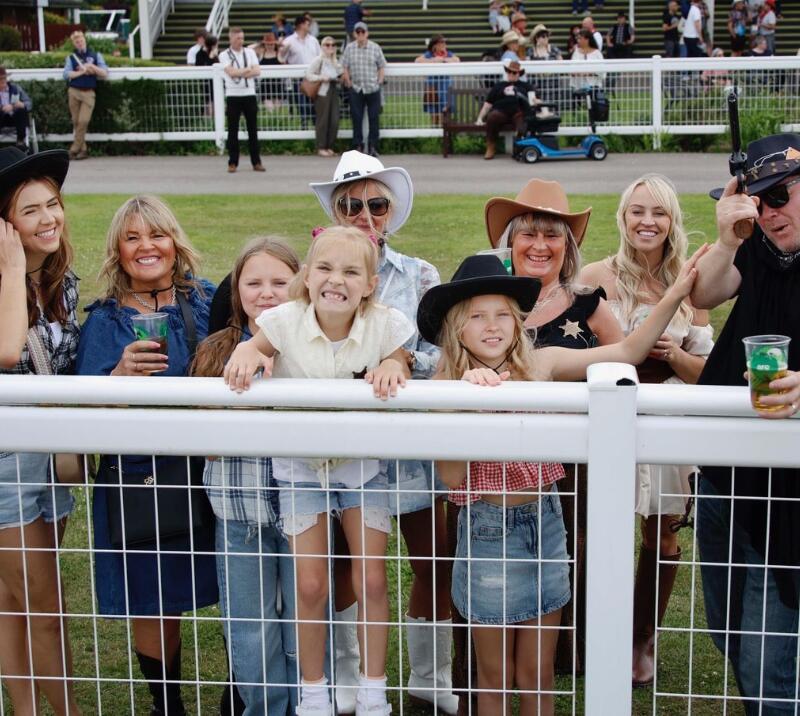A family group at Southwell Racecourse dressed up for a country and western theme