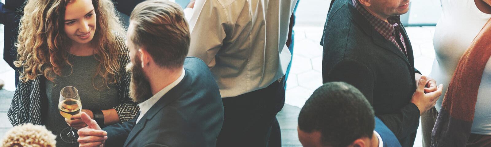 Crowd of people networking at an event.