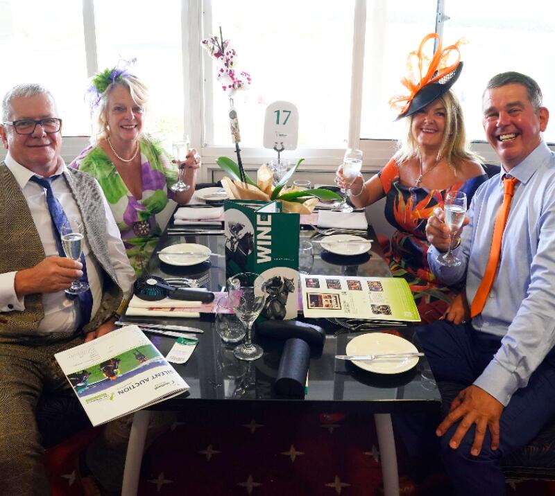A group of hospitality guests enjoying their table at Southwell Racecourse.