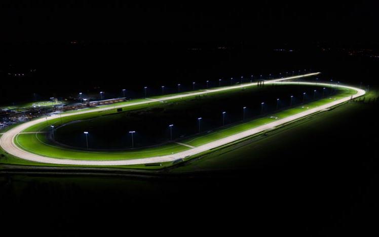 A view of a floodlit racing track